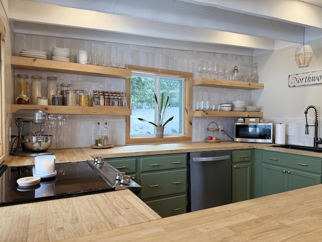 kitchen featuring wood counters, stainless steel appliances, and green cabinetry