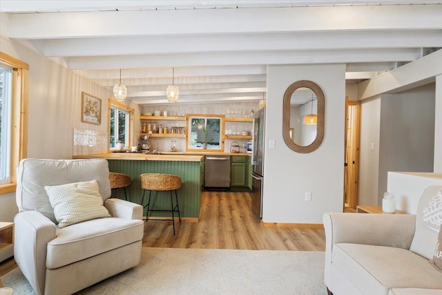 living room featuring lofted ceiling with beams, indoor bar, and light hardwood / wood-style floors