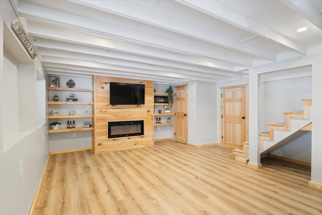 living room featuring beamed ceiling and light wood-type flooring