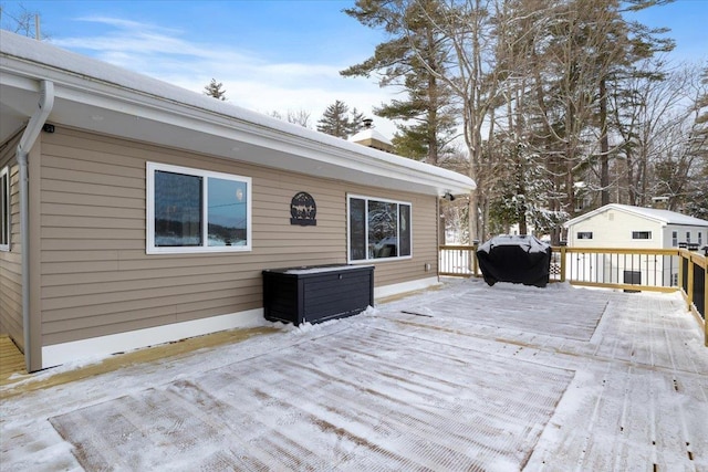 snow covered deck with grilling area