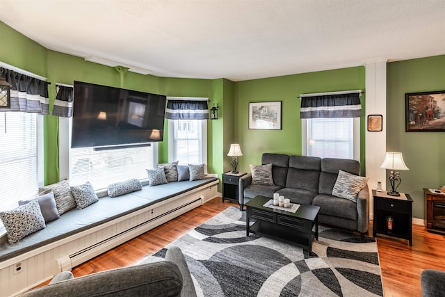 living room featuring a baseboard radiator and hardwood / wood-style floors