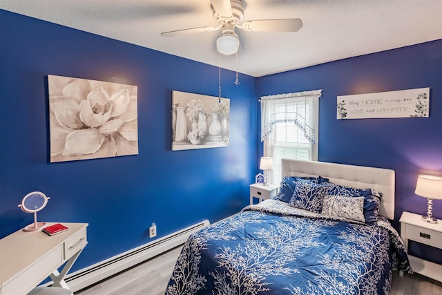 bedroom featuring ceiling fan, a baseboard radiator, wood-type flooring, and a textured ceiling