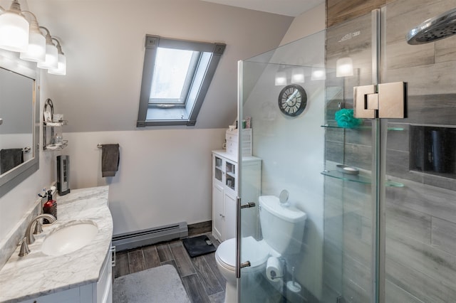 bathroom with vanity, lofted ceiling with skylight, a shower with door, and a baseboard heating unit