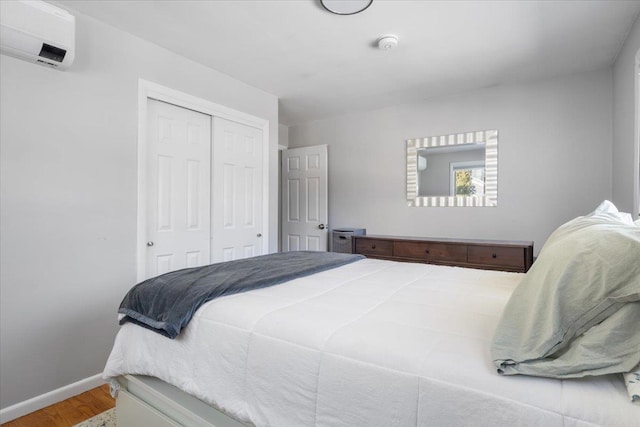 bedroom featuring hardwood / wood-style floors and a closet