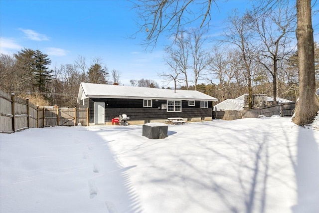 view of snow covered back of property