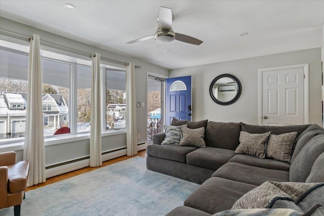 living room with light hardwood / wood-style floors and ceiling fan