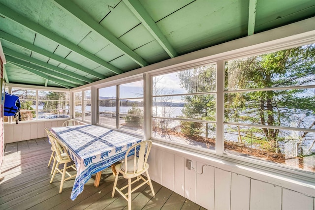 sunroom featuring vaulted ceiling with beams