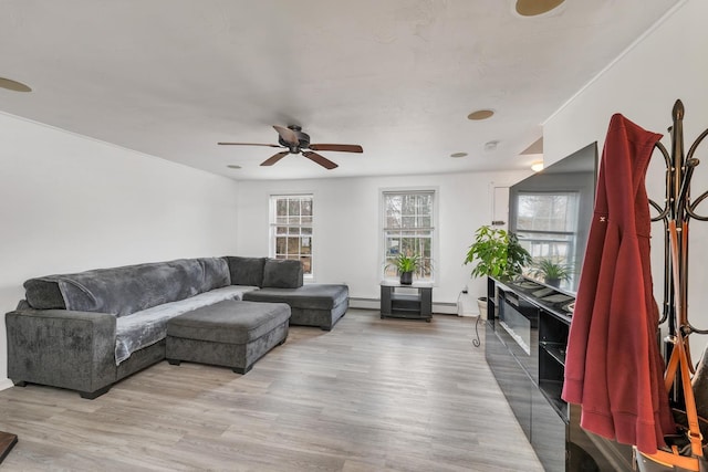 living room featuring light hardwood / wood-style floors, ceiling fan, and baseboard heating