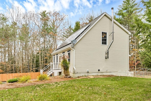 view of side of home with a yard