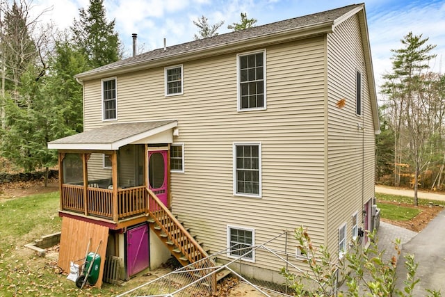 back of property with a sunroom