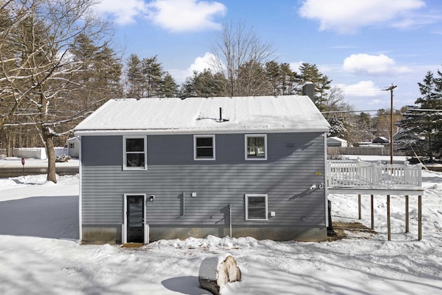 view of snow covered back of property