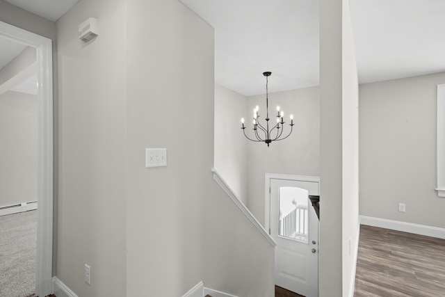 foyer featuring an inviting chandelier and hardwood / wood-style floors