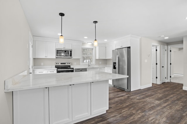 kitchen featuring white cabinetry, sink, hanging light fixtures, light stone counters, and stainless steel appliances