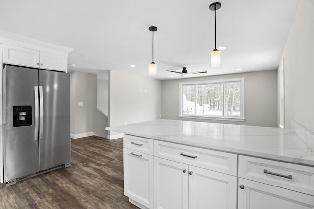 kitchen featuring white cabinetry, light stone countertops, dark hardwood / wood-style floors, and stainless steel fridge