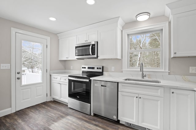 kitchen with white cabinetry, appliances with stainless steel finishes, and sink