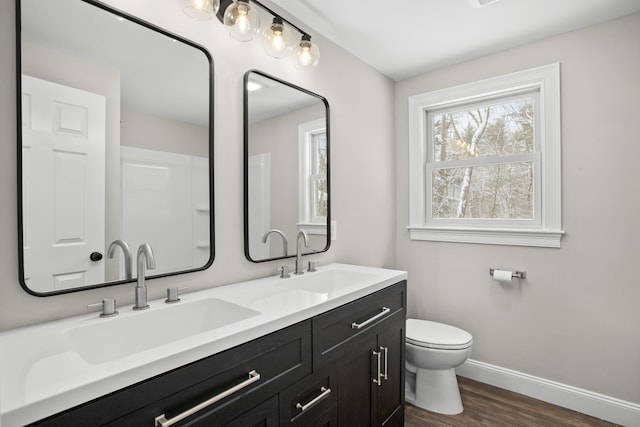 bathroom featuring hardwood / wood-style flooring, vanity, and toilet