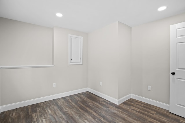 spare room with dark wood-type flooring