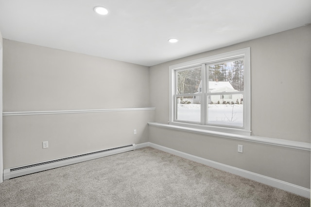 empty room with a baseboard heating unit and carpet