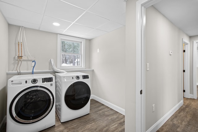 washroom featuring washing machine and dryer and dark hardwood / wood-style flooring