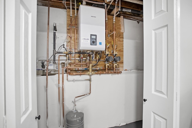 utility room featuring tankless water heater