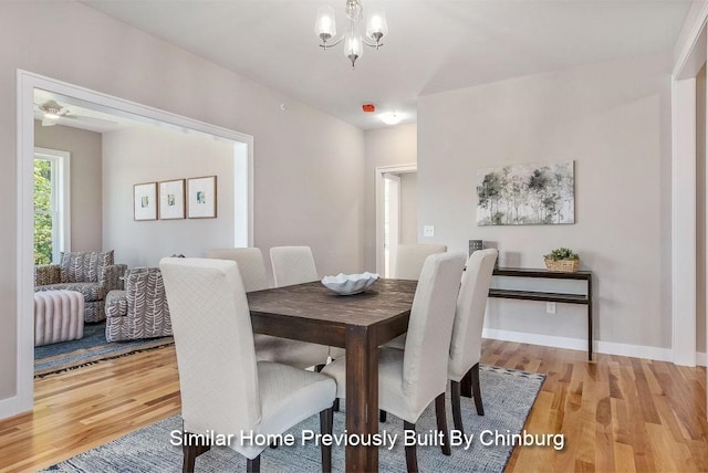 dining area featuring an inviting chandelier and light hardwood / wood-style floors