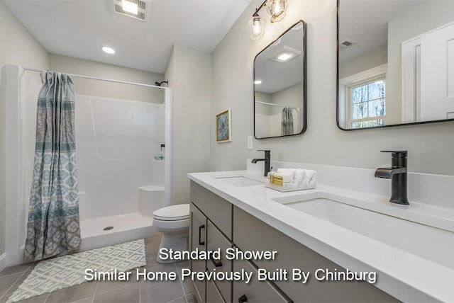 bathroom featuring walk in shower, vanity, toilet, and tile patterned flooring