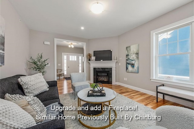 living room with hardwood / wood-style flooring and a tiled fireplace