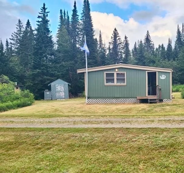 view of outbuilding featuring a lawn