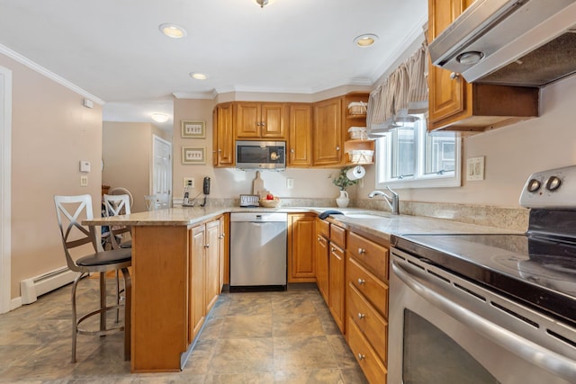 kitchen with a breakfast bar, ventilation hood, baseboard heating, appliances with stainless steel finishes, and kitchen peninsula