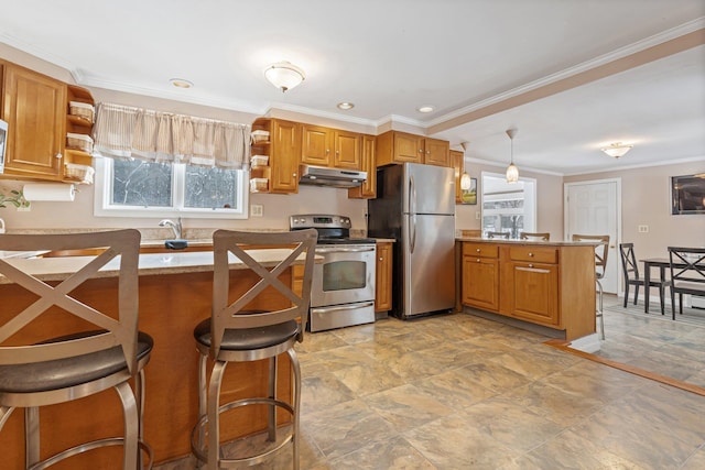 kitchen with a kitchen bar, hanging light fixtures, ornamental molding, appliances with stainless steel finishes, and kitchen peninsula