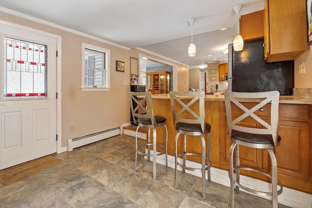 kitchen with a breakfast bar area, stainless steel fridge, ornamental molding, a baseboard heating unit, and kitchen peninsula