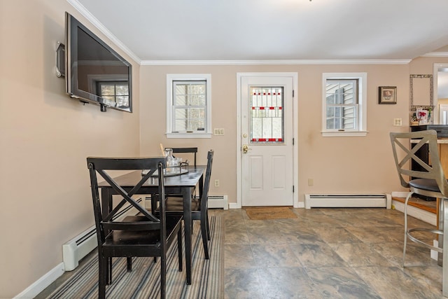 dining room featuring crown molding, a healthy amount of sunlight, and baseboard heating