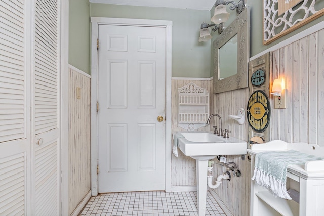 bathroom with sink and wooden walls