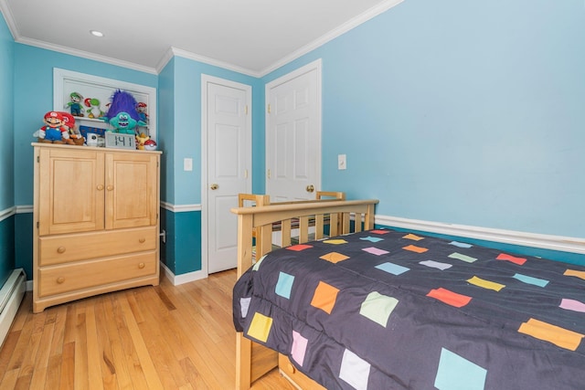 bedroom with crown molding and light hardwood / wood-style flooring