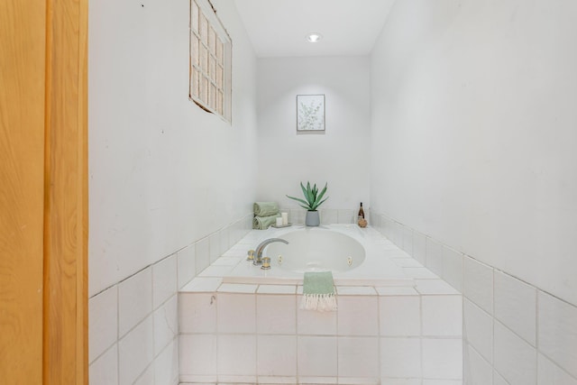 bathroom featuring a relaxing tiled tub