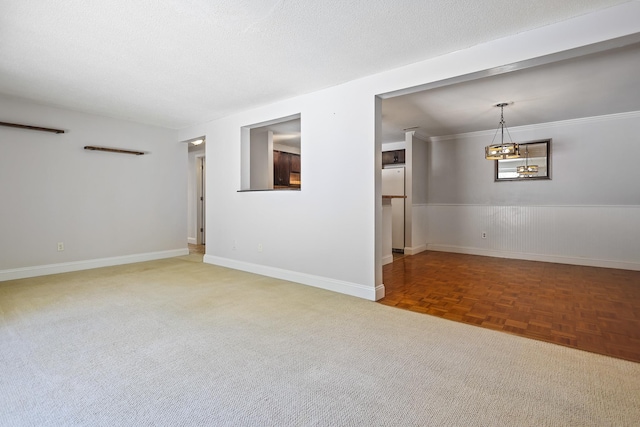 spare room featuring parquet flooring and a textured ceiling