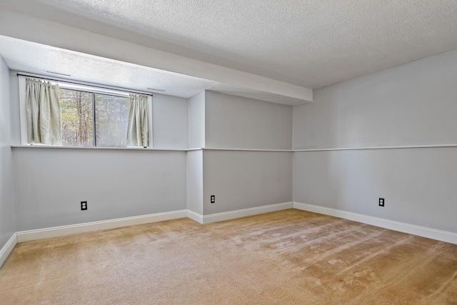 carpeted spare room with a textured ceiling