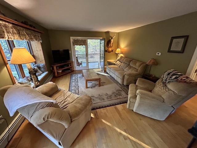 living room with light hardwood / wood-style flooring and baseboard heating