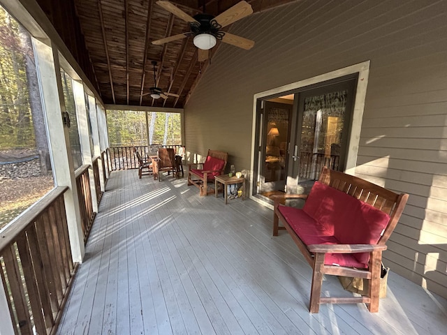 unfurnished sunroom with vaulted ceiling and ceiling fan