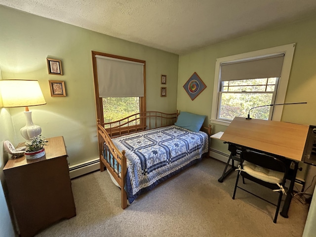 bedroom with a baseboard radiator, carpet floors, and a textured ceiling