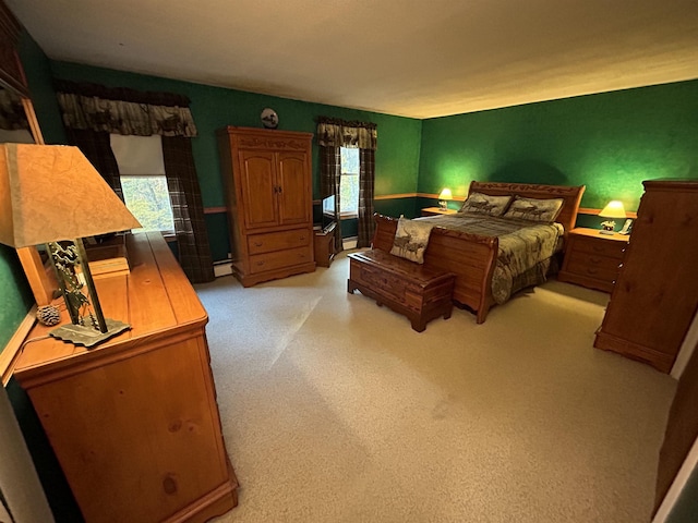 carpeted bedroom with multiple windows and a baseboard heating unit