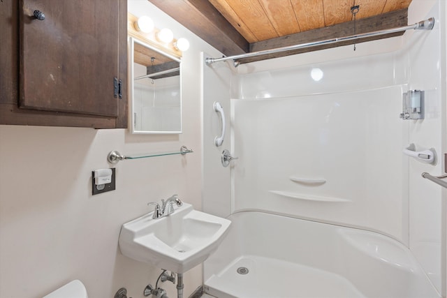 bathroom with wood ceiling, toilet, sink, and a shower