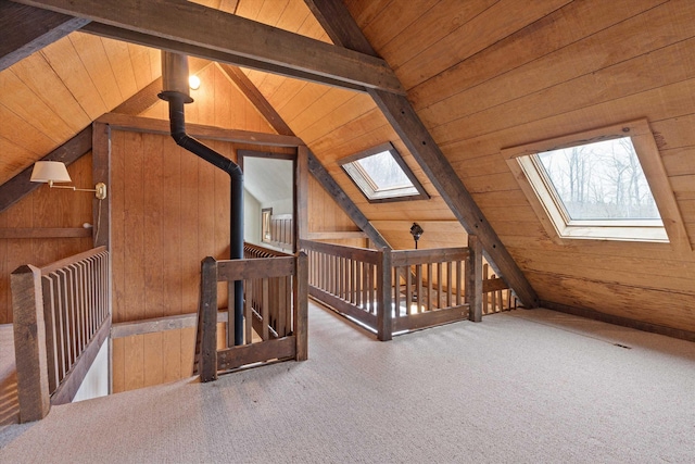 bonus room featuring wooden walls, vaulted ceiling with skylight, carpet, and wooden ceiling