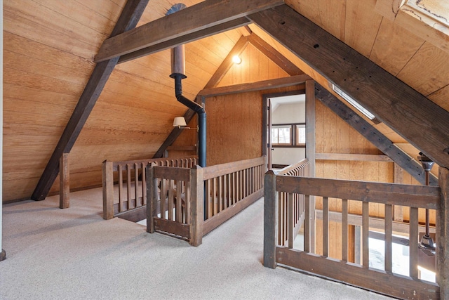 additional living space featuring wooden ceiling, carpet floors, lofted ceiling with beams, and wood walls