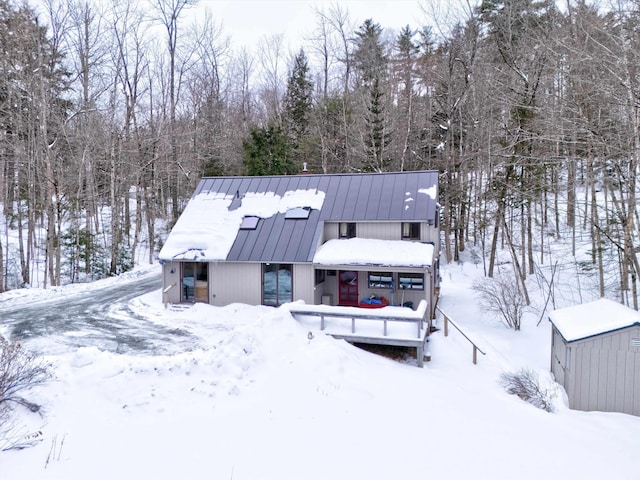 view of snow covered rear of property