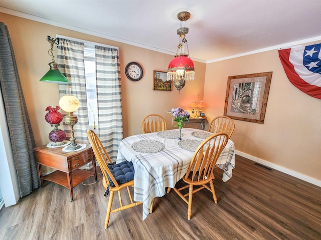 dining room featuring wood-type flooring and ornamental molding