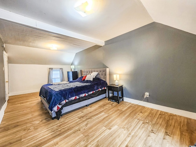 bedroom with lofted ceiling and light hardwood / wood-style floors