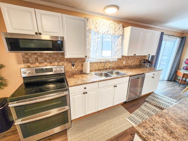 kitchen featuring white cabinetry, appliances with stainless steel finishes, sink, and a healthy amount of sunlight