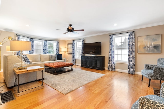 living room featuring crown molding, hardwood / wood-style floors, and ceiling fan