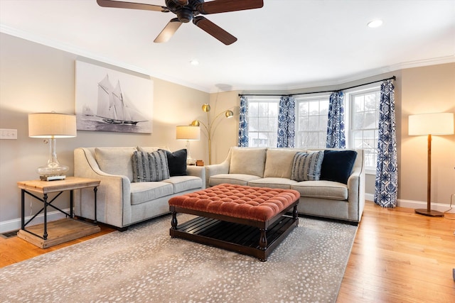 living room with ornamental molding, hardwood / wood-style floors, and ceiling fan